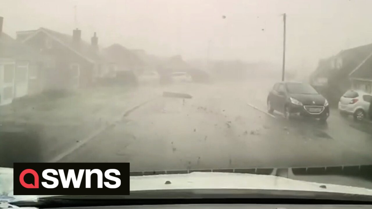 UK driving instructor has lucky escape after mini-tornado blows FENCE across busy road