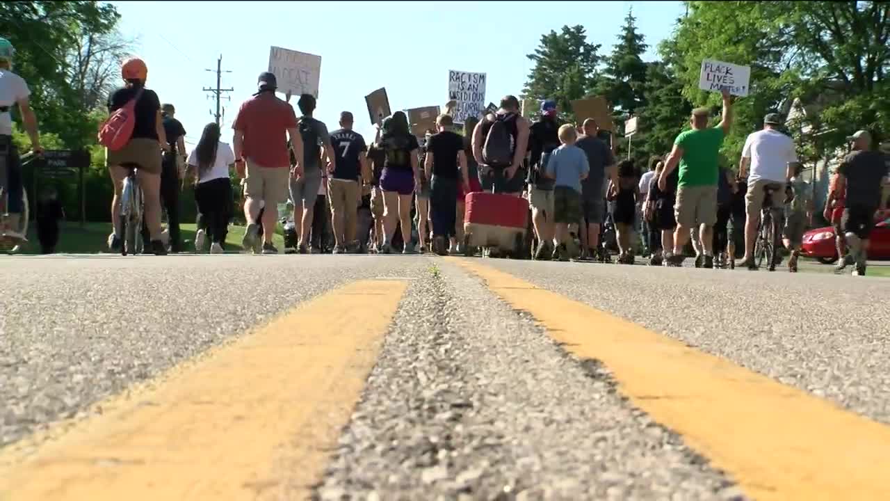 Protestors march to the home of Menomonee Falls Trustee