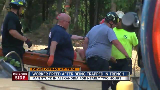 Worker free after being trapped in trench