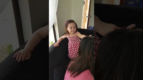 Cute nommy plays with her baby girl, tickles her and makes her laugh