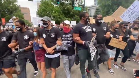 'If you ain't with us, you against us:' Broncos players join protests, lead march through Denver