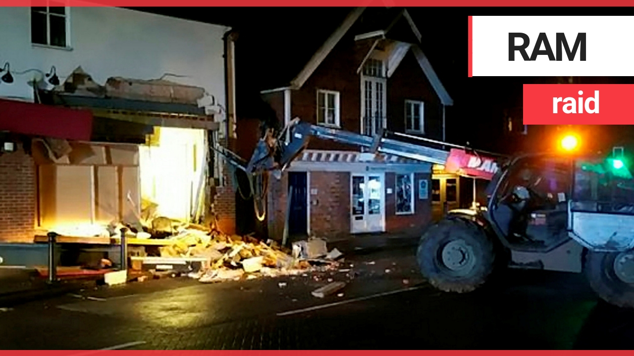 Thieves demolished half a supermarket with a crane