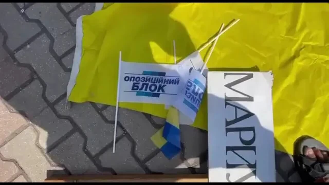 Ukrainian flags thrown to the ground in Mariupol. The citizens have been waiting 4 this for 8 years.