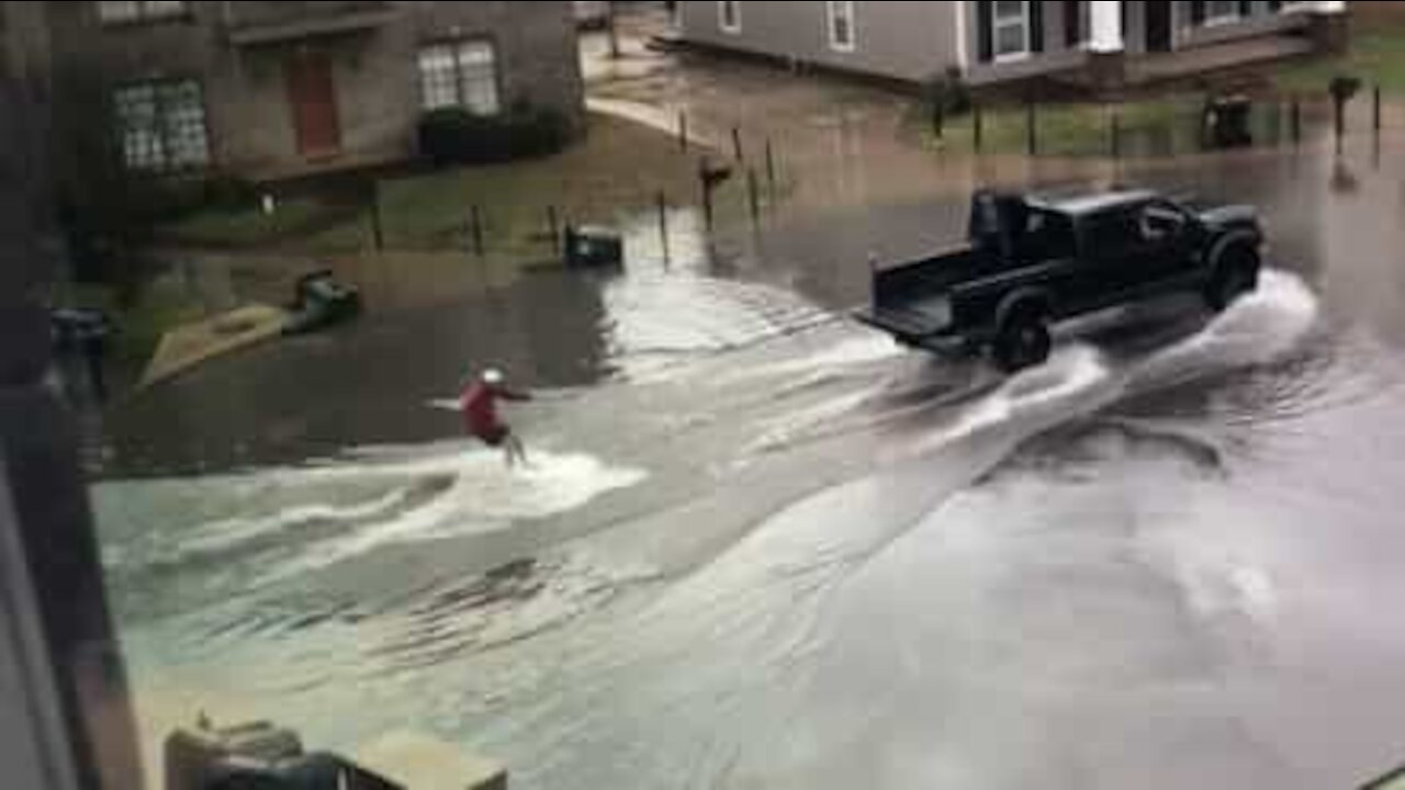 Guy goes water skiing during floods