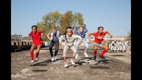 The dance crew performing with little girls