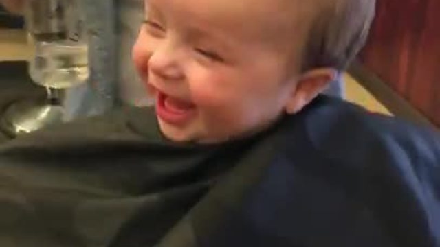 Cheerful Baby Boy Loves His First Haircut