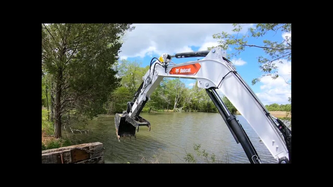 Setting 1,800 lb. bridge timbers for bridge project