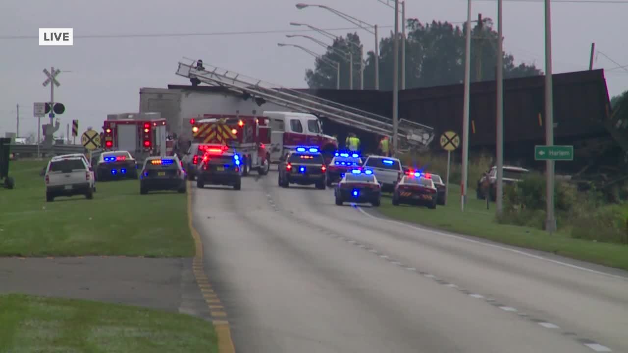 Train off tracks after hitting truck