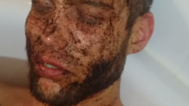 Guy ironically falls asleep with coffee on his face in the tub