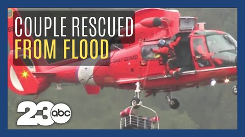 Coast Guard rescues couple and dog trapped by flood