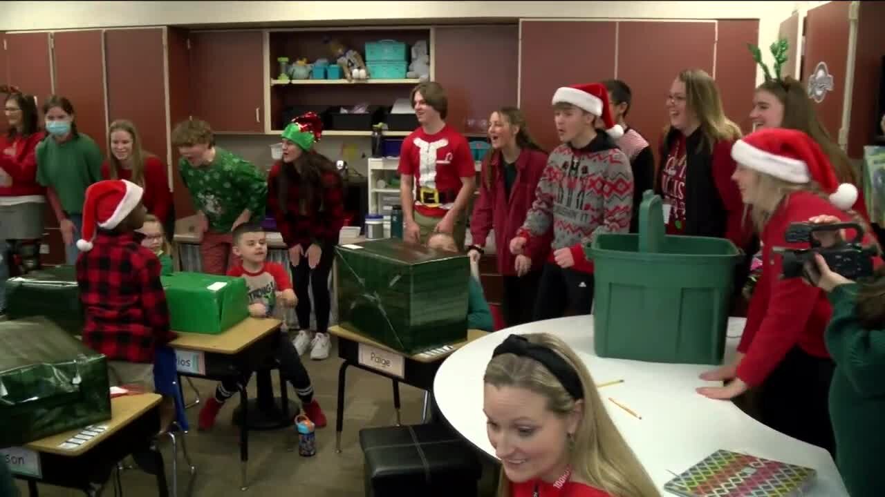 Oconomowoc High School students give presents to more than 200 Hadfield Elementary students