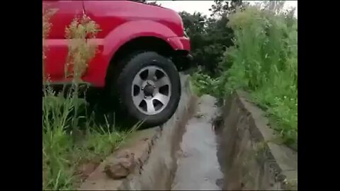 Car Drives Over Trench