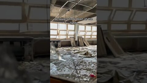 Scrappers taking down all the lights inside an abandoned Chicago school￼