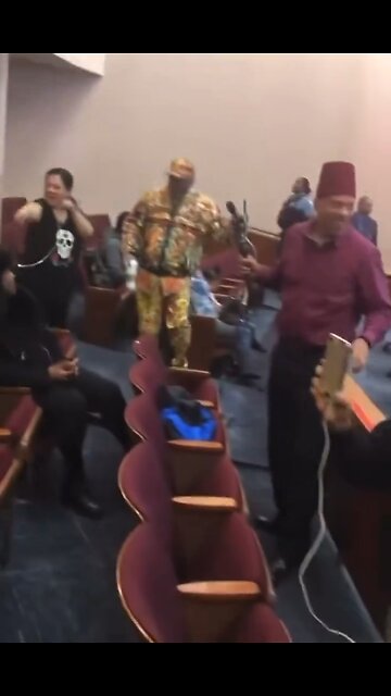 Citizens at a Chicago City Council meeting chant “Go Red, No More Blue, No Matter Who”