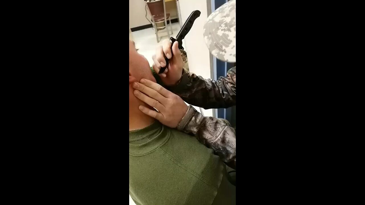 Cutting open a giant boil on Marines face with knife