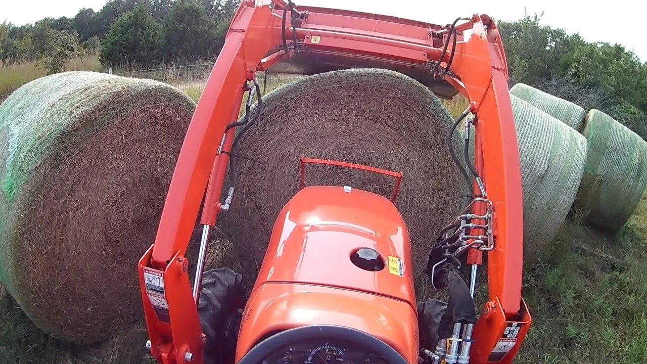 Kubota L2501 moving hay.