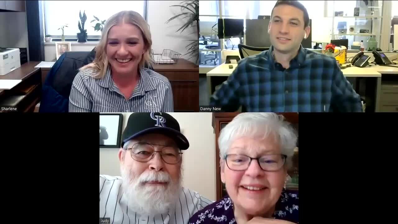 Senior couple speaks with photographer behind beloved Rockies picture of them