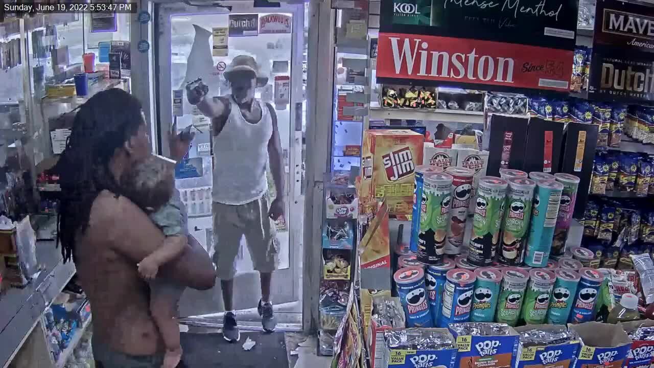 Photos show suspect pull gun on man holding baby at Detroit gas station