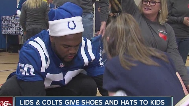 LIDS and Colts give shoes and hats to kids at Hawthorne Elementary School