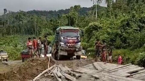 it's scary the truck crosses the wooden bridge