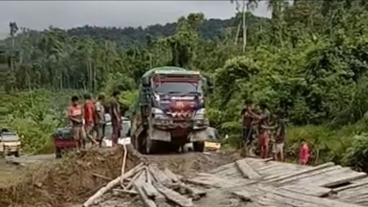 it's scary the truck crosses the wooden bridge