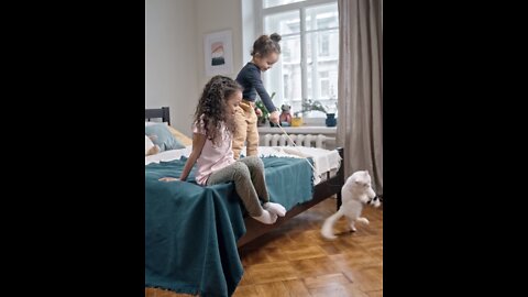 Kids Playing Catch The Bait With Their Cat In The Bedroom