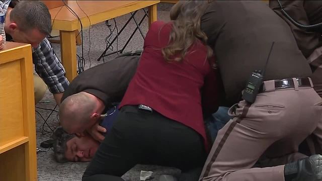 Victim's father handcuffed in court after charging at Larry Nassar