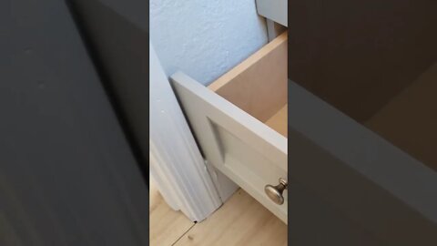 Would you keep the bathroom vanity close to the wall, or bump it out so you can use the drawer?