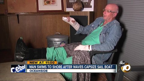 Man swims to shore after waves capsize sail boat