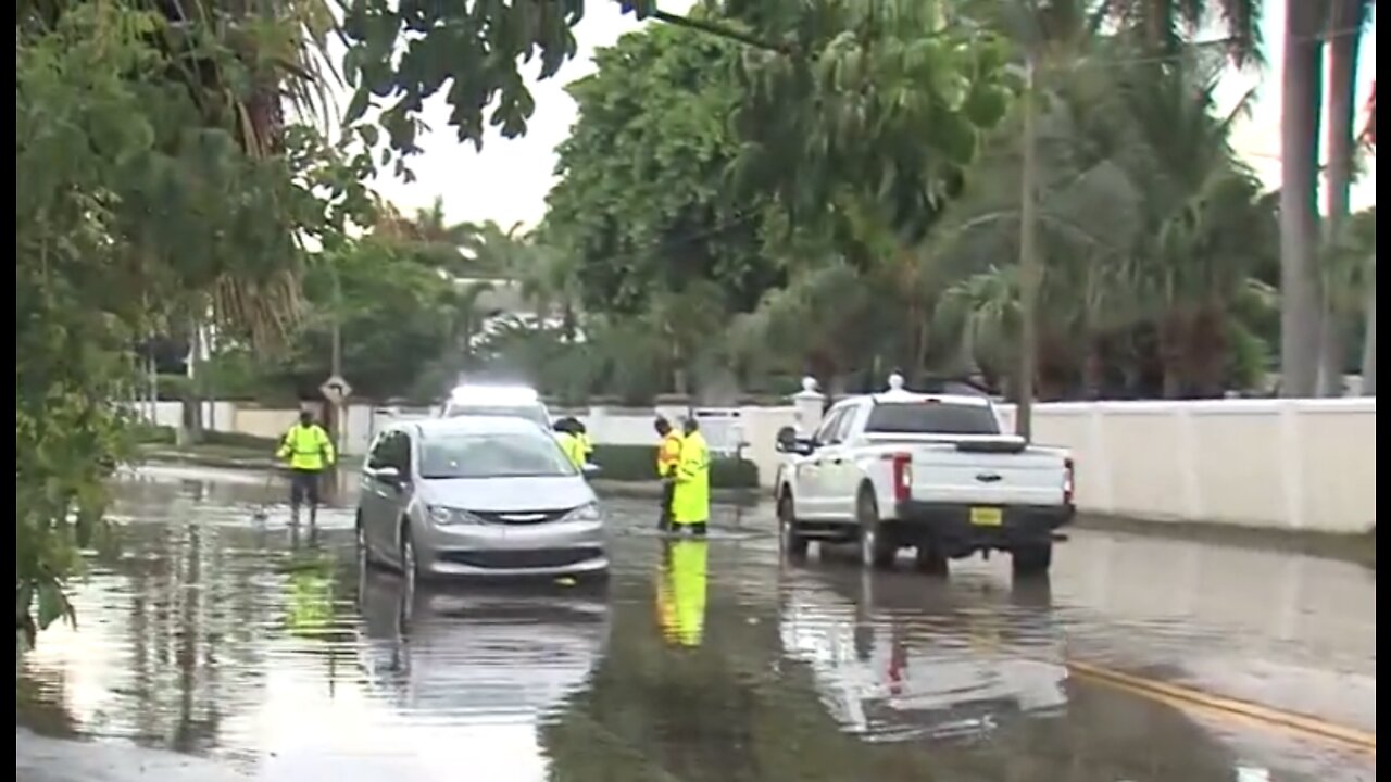 Streets flooded, car stuck in West Palm Beach