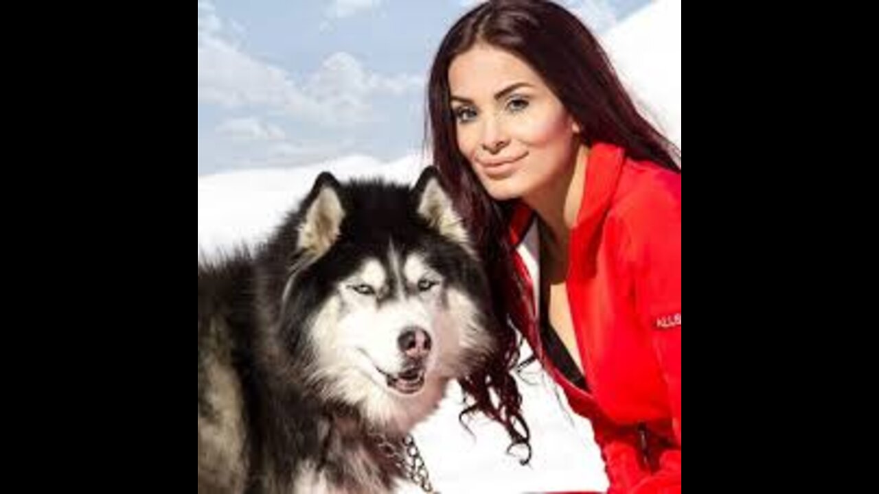 A woman petting a beautiful dog