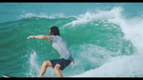 A Male Surfer Riding Skillfully The Sea Waves