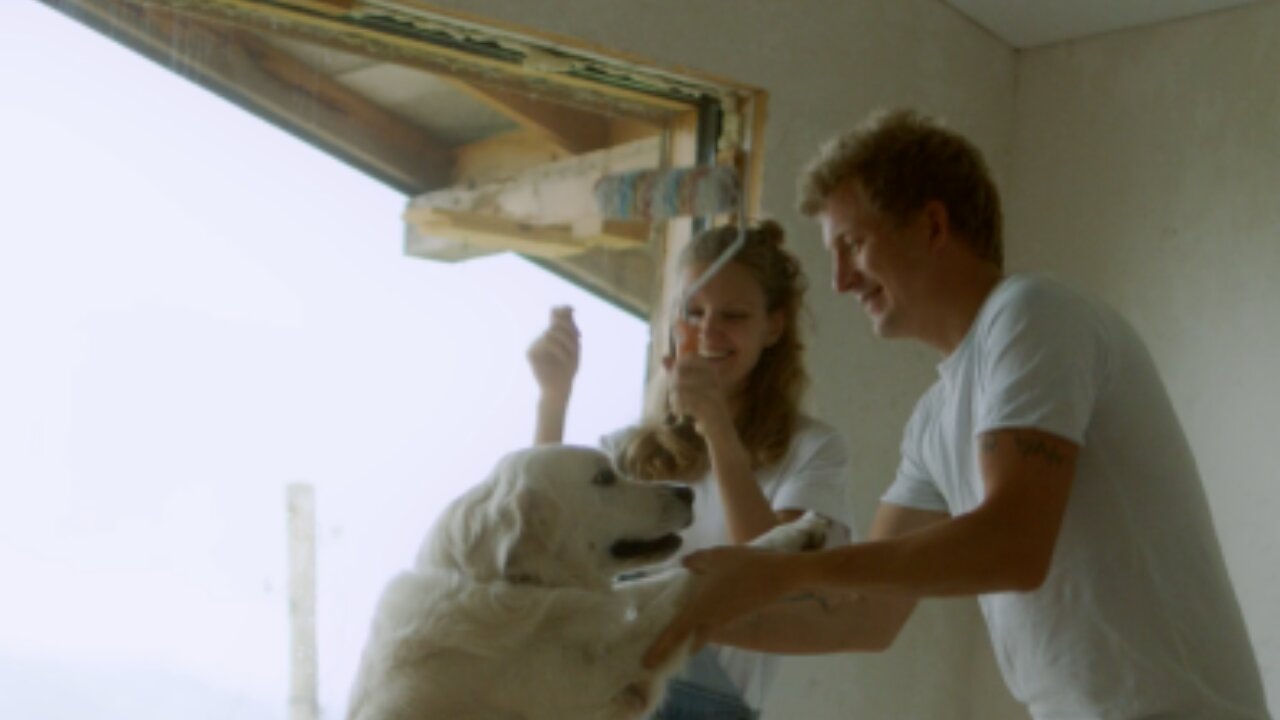 A happy couple dancing with their new white Central Asian Shepherd dog by funny dog videos