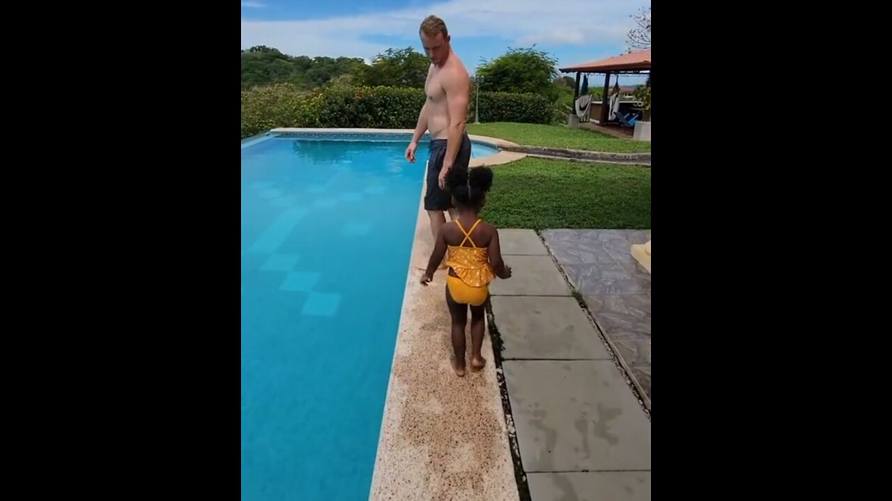 Cute daughter pushed dad into the pool.