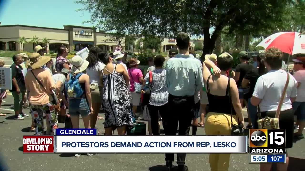 Protesters against immigration detention camps gather outside Rep. Debbie Lesko's office