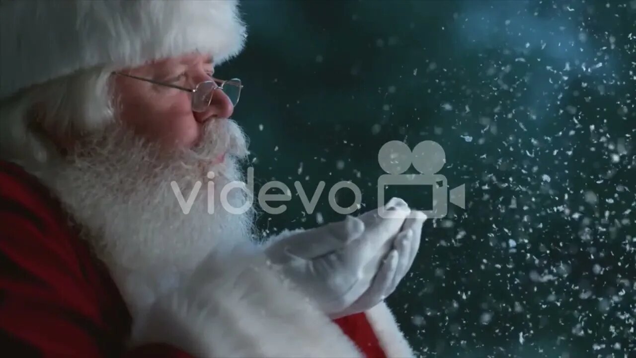 Santa Claus blowing snow from hands