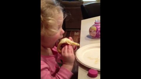 A Tot Girl Struggles To Put A Slice Of Pizza In Her Mouth