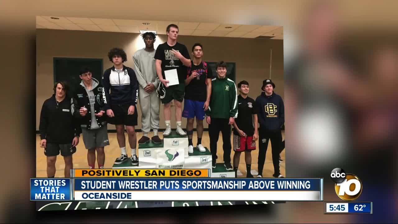 Boy hands over wrestling medal