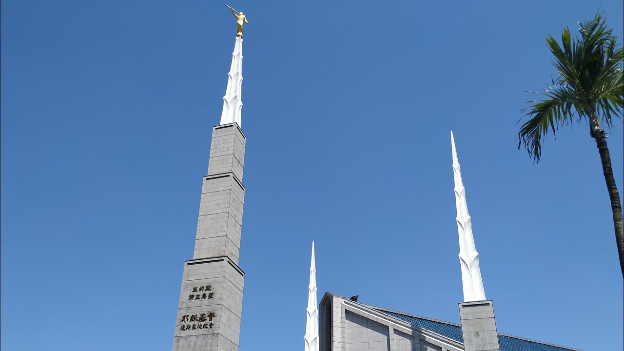 Chatting with some Mormons next to their temple, Taipei ..with their "angel" Moroni (steeple)