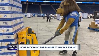 Lions pack food for families at Huddle for 100