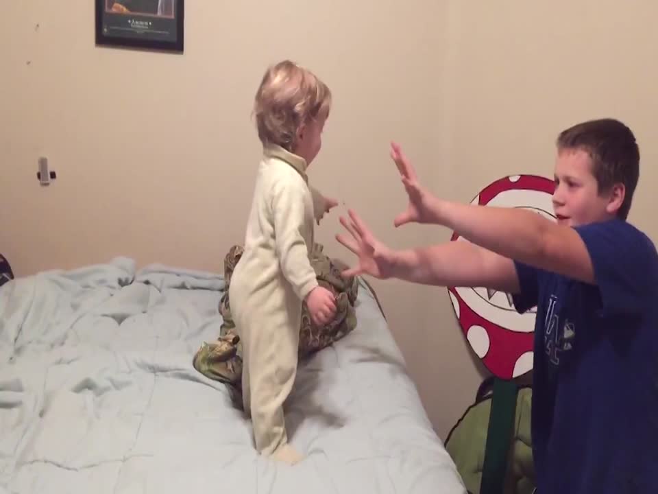 Silly Siblings Pretend to Knock over Baby