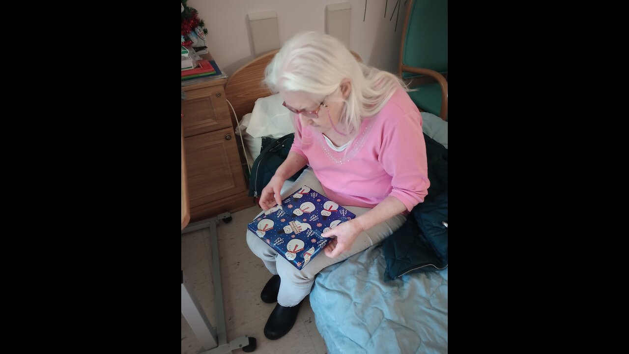 Mom opening a late Christmas gift.