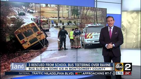 School bus winds up teetering over ravine after sliding off icy road