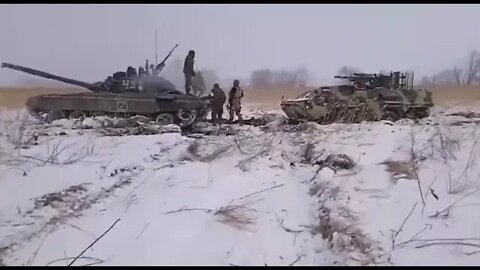 Russian T-72B3 trying to pull out an abandoned Ukrainian BTR 4 armored vehicle