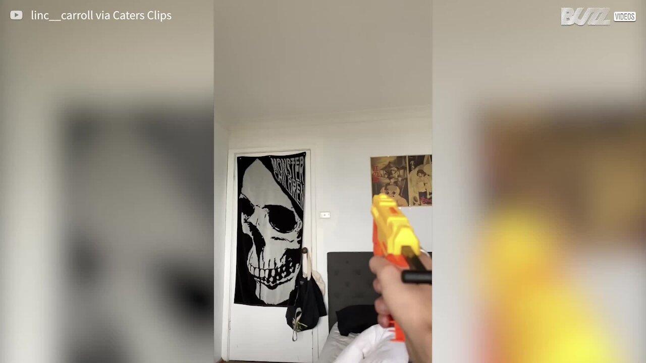 Young man hits fly with Nerf gun