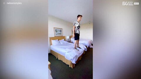 Guy backflips his way into bed to go to sleep