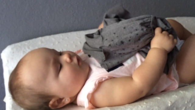 A Fashionista Baby Choosing Her Outfits Will Make Your Day