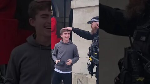 Armed police officer parts tourist on the head #horseguardsparade