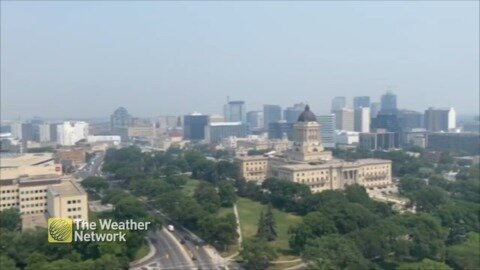 The air looks hard to breathe as it looms over the city