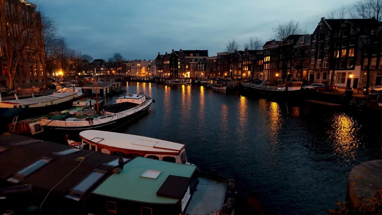 Evening rain on a calm channel in Amsterdam